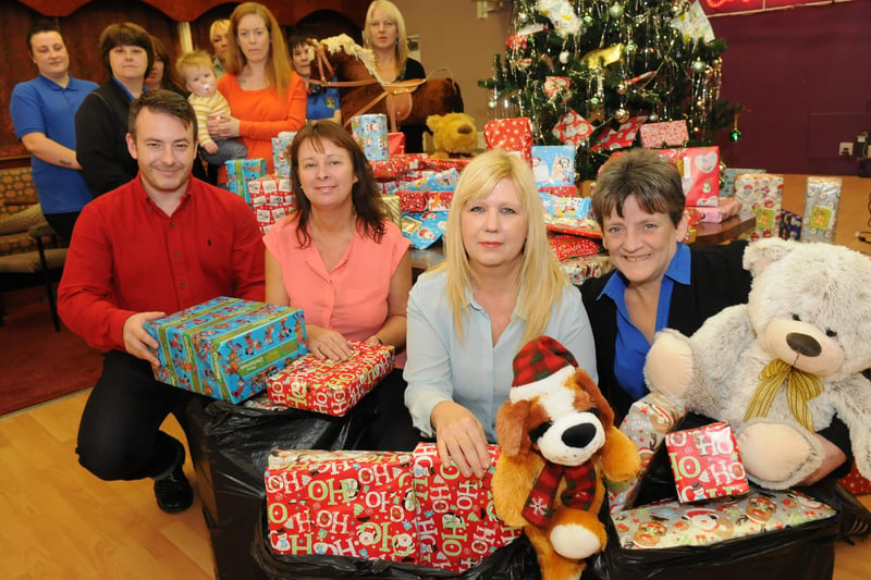 Crown Bingo owner Rob Garrard, left, and manager Maria Burrell, right, hand over Christmas gifts to Angie Allen and Kathryn McClafferty of People for Places. Remember this from 2014?