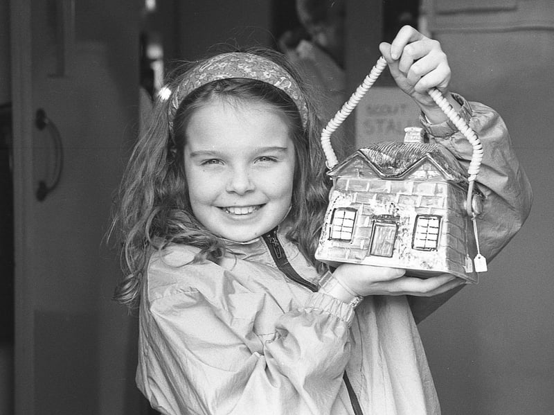 Pictured in March 1992 is Erin Bunting of 1st Hillsborough Brownies with a 1920 Cottage Ware biscuit basket at an antiques and collectables fair which had been organised by 1st Hillsborough Scout Troop at the Downshire Hall. Picture: News Letter archives