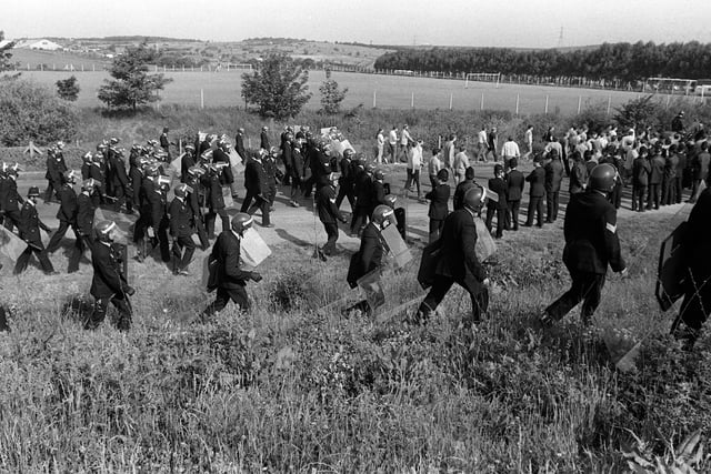 Pickets are moved on by police at Orgreave and usher them towards Catcliffe.