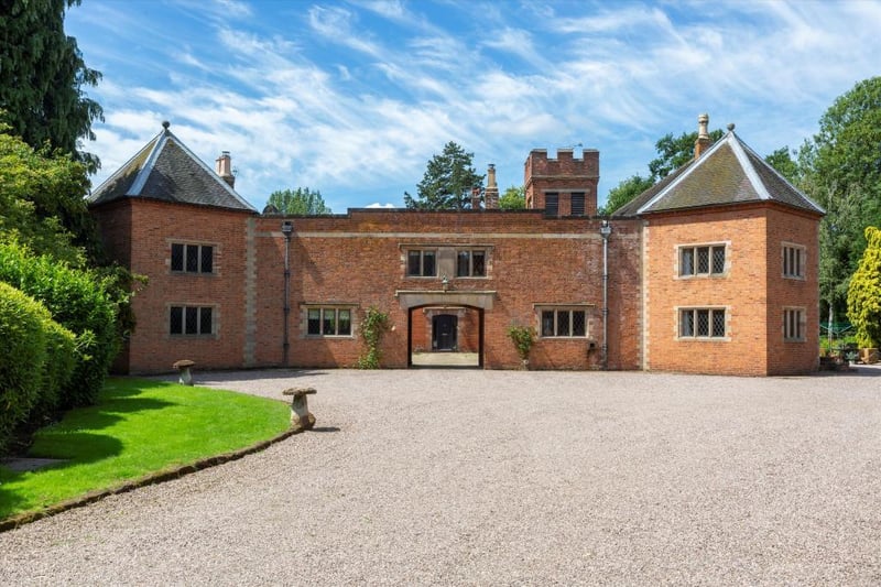Two of the estates four cottages sit either side of an archway into a courtyard by the private chapel.
