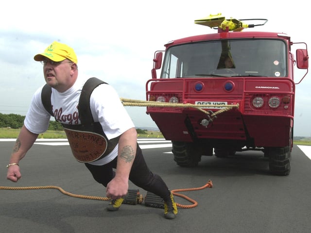 Strong man Tony Simpson is pictured pulling a giant fire truck at Sheffield City Airport for the PHAB charity.