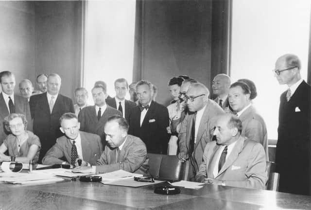 UNHCR. Signature of the 1951 Refugee Convention in Geneva, Switzerland / the three seated men (l-r): Mr. John Humphrey, Director of the Human Rights Division; Mr. Knud Larsen (Denmark) President of the Conference; Dr. G.V. van Heuven Goedhart, High Commissioner for Refugees / copyright Arni / UN Archives / August 1, 1951.