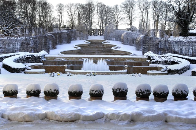 The beautiful snow-covered grand cascade at The Alnwick Garden.