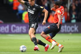 Sander Berge of Sheffield Utd tackled by Gabe Osho of Luton Town during the Sky Bet Championship match at Kenilworth Road: Simon Bellis / Sportimage