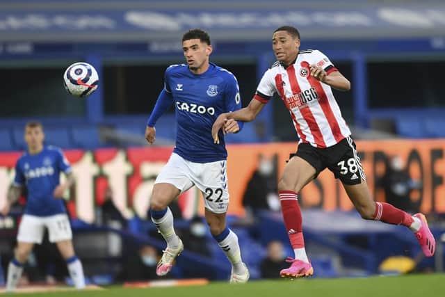 Everton's Ben Godfrey, left, and Sheffield United's Daniel Jebbison challenge for the ball during the English Premier League soccer match between Everton and Sheffield United at Goodison Park in Liverpool, England, Sunday, May 16, 2021. (Gareth Copley/Pool via AP)