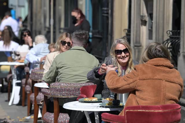 People raising their glasses as pubs with outdoor facilities reopened on April 30, 2021. Photo by Charles McQuillan/Getty Images.