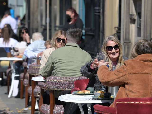 People raising their glasses as pubs with outdoor facilities reopened on April 30, 2021. Photo by Charles McQuillan/Getty Images.