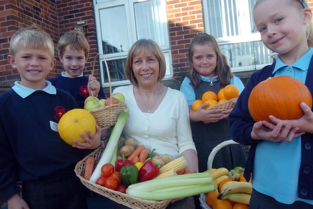Angela Satur, project worker at St Wilfred's Centre, Sheffield, accepted harvest festival gifts from Sacred Heart School pupils in 2007. Pupils L-R Ellis Burrows,six, Nathan Blakemore, six, Courtney Easton, six and Laura Wordsworth, six.