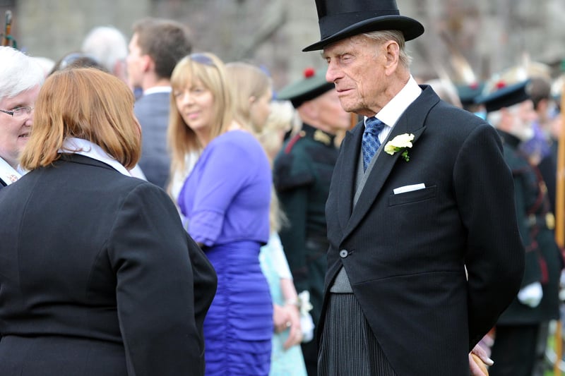 Royal Garden Party at the Palace of  Holyrood House, Edinburgh, 2015. Her Majesty the Queen and HRH the Duke of Edinburgh speak with guests.