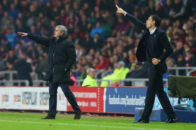 Jose Mourinho manager of Chelsea and Gustavo Poyet manager of Sunderland signal from the touchline.