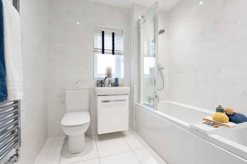 Family bathroom with white thre piece suite and over bath shower.