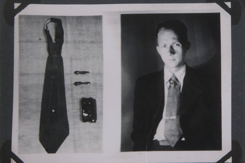 A Soviet KGB spy silk necktie with a hidden "Tochka-58" camera concealed with use of a fake tie clip. Includes hand activated shutter release mechanism.