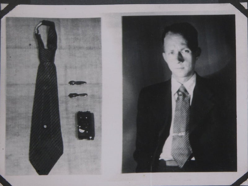 A Soviet KGB spy silk necktie with a hidden "Tochka-58" camera concealed with use of a fake tie clip. Includes hand activated shutter release mechanism.