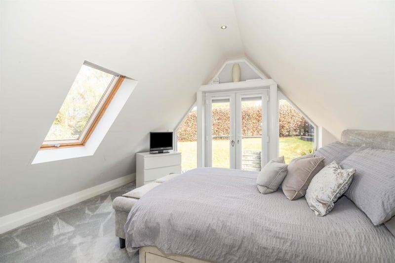 The impressive master bedroom has a vaulted ceiling with recessed spotlighting. There is a double-glazed skylight having views towards Bakewell and central heating radiator. Double-glazed French doors with a glass Juliet balcony open to provide fantastic views over the landscaped rear gardens.