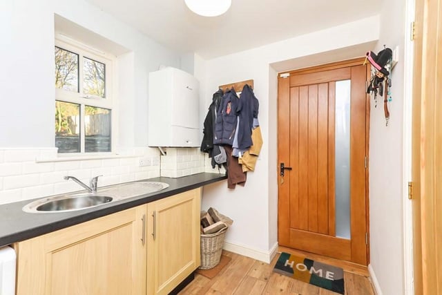 The utility room is sure to come in handy. It houses the boiler, and there is space and plumbing for a washing machine. The room also includes hardwood flooring, side-facing, double-glazed windows and a central heating radiator.