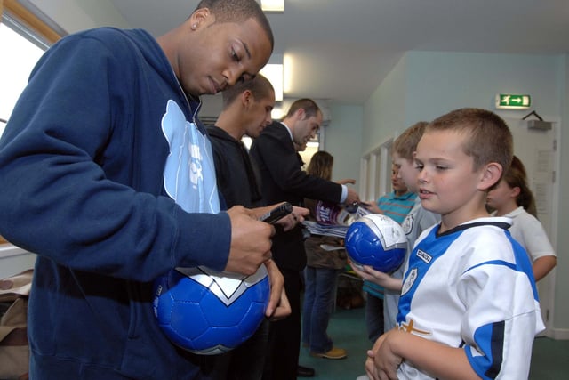13th July 2007.
Sheffield Wednesday players meet children from the Winn  Gardens estate which was badly hit by the floods in 2007. Wade Small signs a football for a young fan.