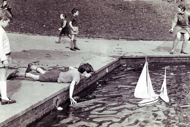 Children make the most of the sun and holiday at the Firth Park model boat lake in April 1969
