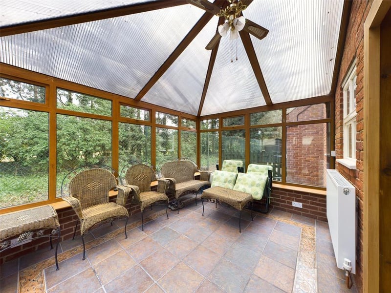 uPVC double glazed panels with dwarf wall and French style doors opening into the rear garden. Tiled floor, radiator panel, power and lighting.