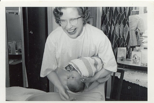 A District Nurse from Nether Edge Hospital visited a family to weigh & bathe a newborn in May 1967