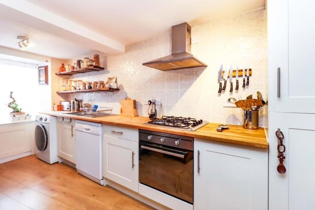 The modern kitchen has ample wall/base mounted units with contrasting work tops and stainless steel sink/drainer, stainless steel gas hob/cooker hood and integrated oven, washing machine, dish washer and fridge freezer.
