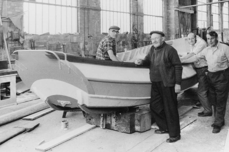 Inside Pounders works with four of their workers posing around a coble. Photo: Hartlepool Museum Service.