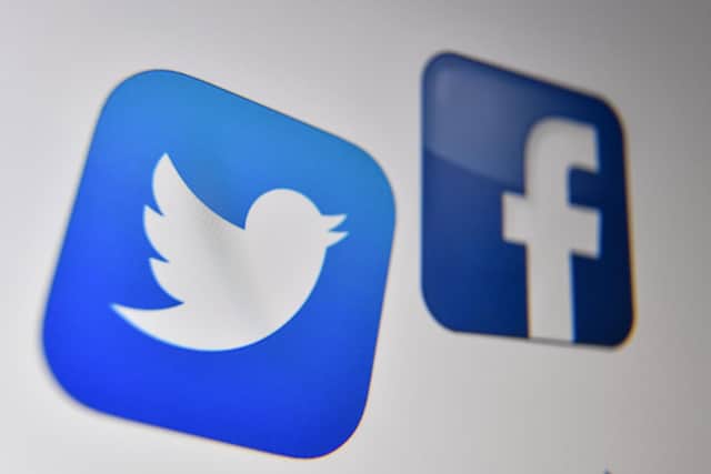 A photo taken on October 21, 2020 shows the logo of the the American online social media and social networking service, Facebook and Twitter on a computer screen in Lille. (Photo by Denis Charlet / AFP) (Photo by DENIS CHARLET/AFP via Getty Images)