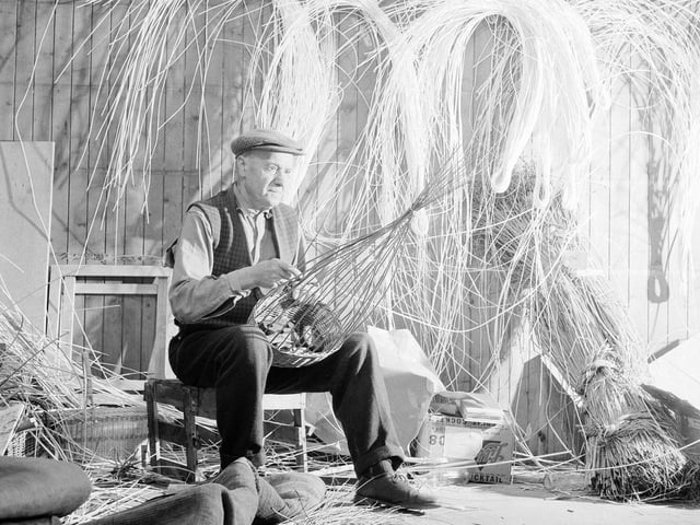 Basket maker William Taylor at work in one of the houses