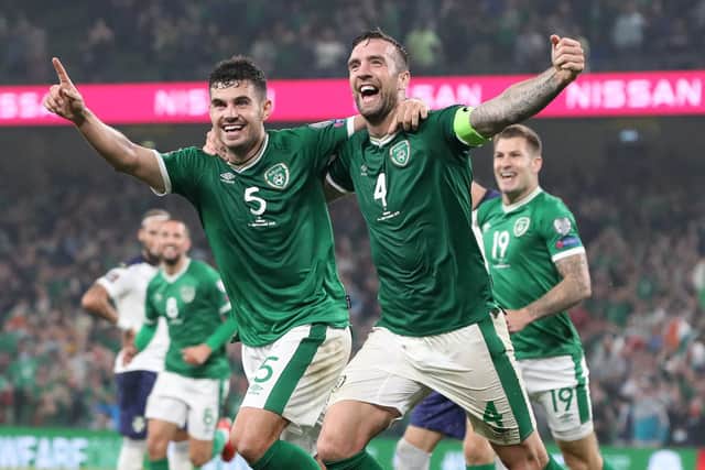 Republic of Ireland's defender John Egan (L) and Republic of Ireland's defender Shane Duffy celebrate after Serbia's defender Nikola Milenkovic (unseen) scored an own goal during the FIFA World Cup Qatar 2022 qualifying round Group A football match between Ireland and Serbia at the Aviva Stadium in Dublin on September 7, 2021. (Photo by PAUL FAITH / AFP) (Photo by PAUL FAITH/AFP via Getty Images)