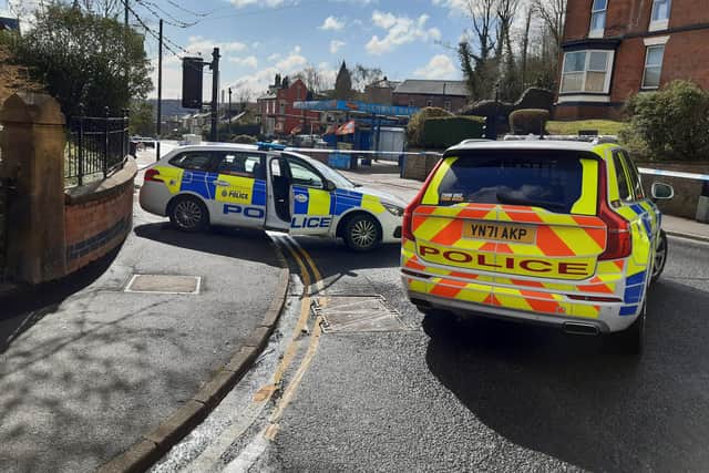 Police cars mark the cordon near the scene of the shooting on Burngreave Road, Sheffield