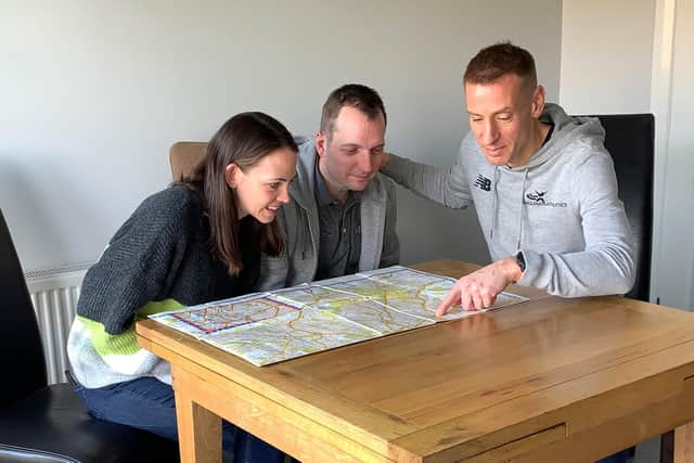 Stephanie and Paul Fauset with their friend Phil Swindin (centre) checking the route plan for the Sheffield Half Marathon