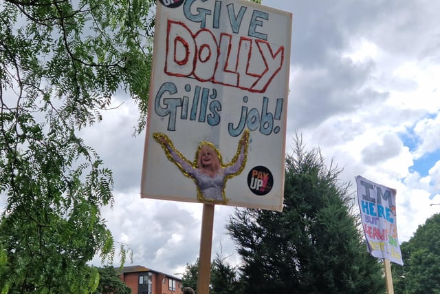 This placard calls for veteran country and pop music star Dolly Parton to take the Secretary of State of Education job from Gillian Keegan. It's not apparent why.