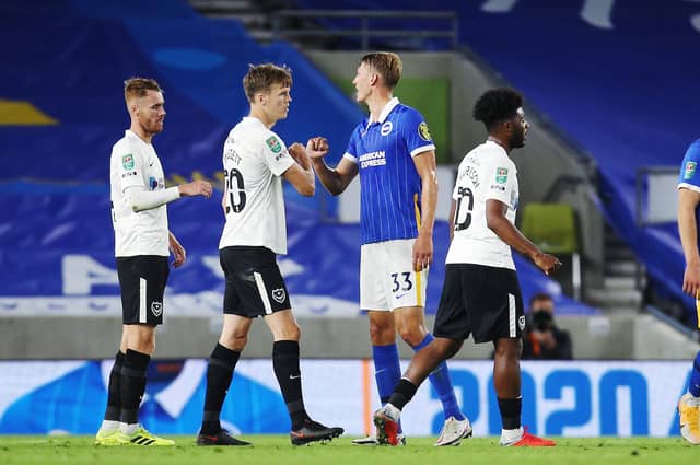 Pompey shake hands after their defeat at Brighton. Picture: Joe Pepler