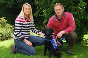 Labrador puppy, Ivanhoe, with his foster parents who are providing vital, initial training in his first months