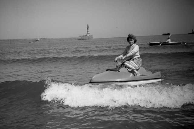 Stella Cleghorn has fun on a water scooter at Roker in 1957.