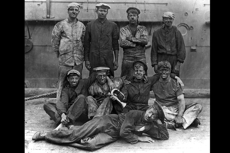 British sailors covered in coal dust after coaling ship.