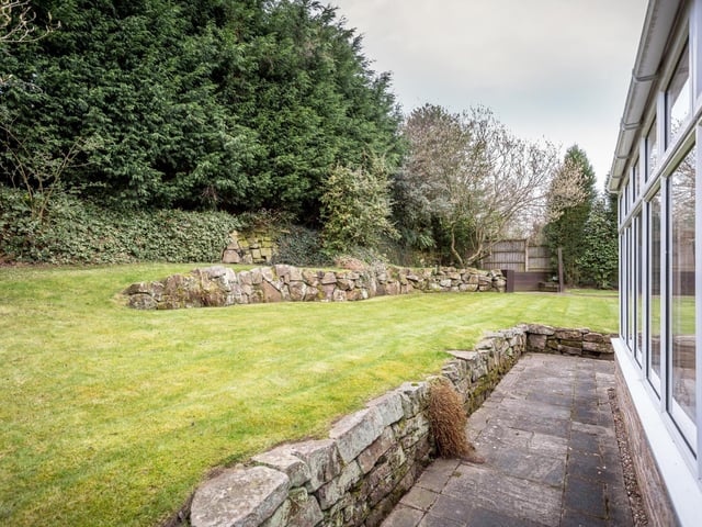 There are "substantial" patios around the house providing "wonderful entertaining space" and a lawned area which is bordered by bedded plants and shrubbery.