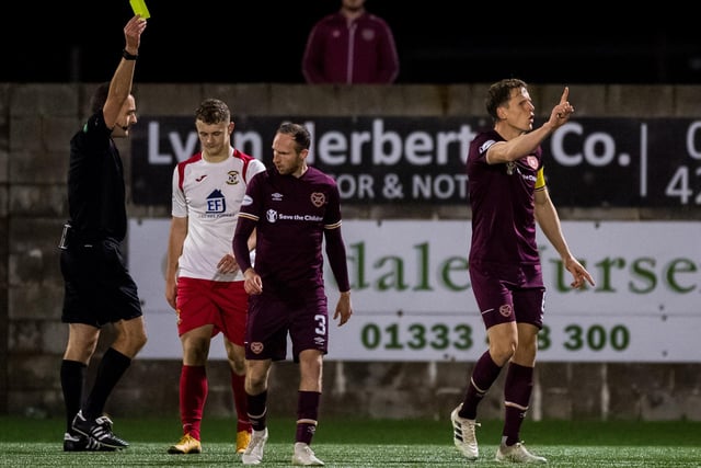 East Fife's Jack Hamilton is shown a yellow card for simulation as Christophe Berra gestures to the sideline during the Betfred Cup match between East Fife and Hearts at Bayview Stadium.  (Photo by Ross Parker/SNS Group)