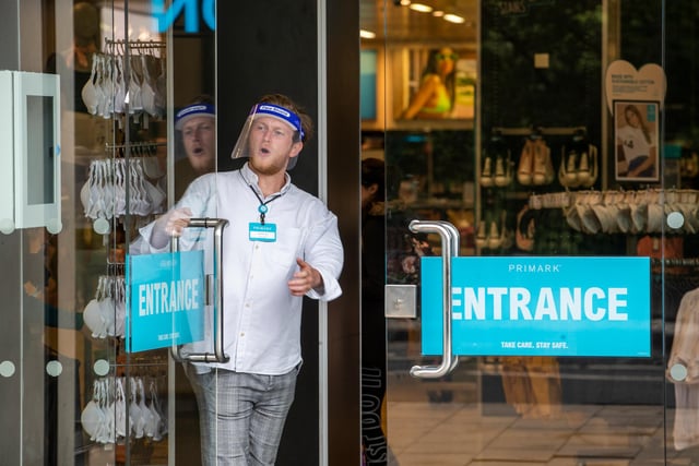 Members of staff at Primark on Princes Street wear face masks as they greet customers.