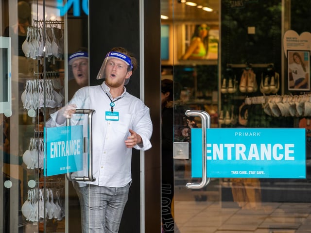 Members of staff at Primark on Princes Street wear face masks as they greet customers.