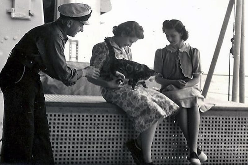 Princess Elizabeth with Minnie the dining hall cat. HMS Vanguard 1947. Picture: John Hucker.