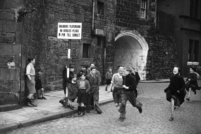 Children running on the old Johnston Street in November 1962. The sign shows the street was a designated children's playground with vehicles banned after 4pm.