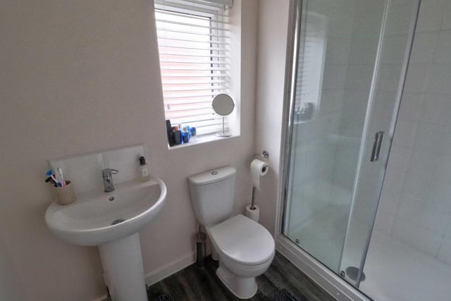 The en suite to the main bedroom features a double shower and a two-piece white suite, comprising hand wash basin and WC. The wet areas are tiled, while the wood-effect, cushioned flooring is a nice touch.