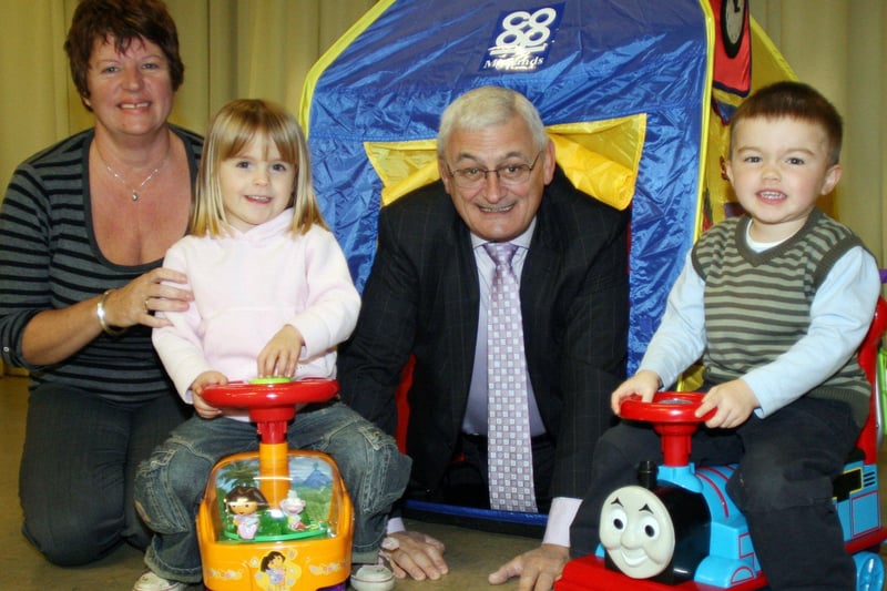 Twinkle Tots playgroup youngsters Daisy Thornelow and Charlie Sharp  try out new toys donated to the playgroup by Chesterfield Co-op in 2007. Plagroup leader Chris Meade and the store manager David Pearce are also on the photo.
