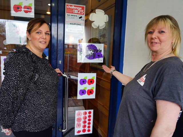 Remembrance display made by local children displayed in the Picture House pub in Sutton. Pictured are Kate Nott duty manager and Lisha Hodson