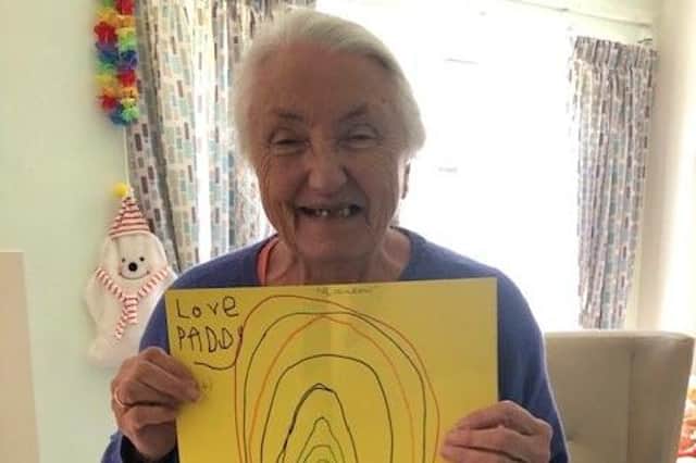 One of the Grenoside Grange residents showing the drawings they were sent.