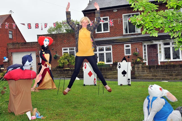 Lynne Olive jumps for joy after winning a scarecrow competition for the third time. Who can tell us more?