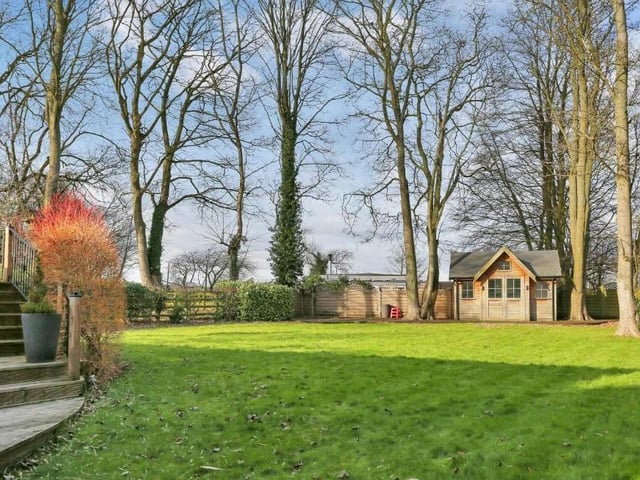 The total size of the plot, on which the house stands, is 0.56 acres. The back includes this large lawn.