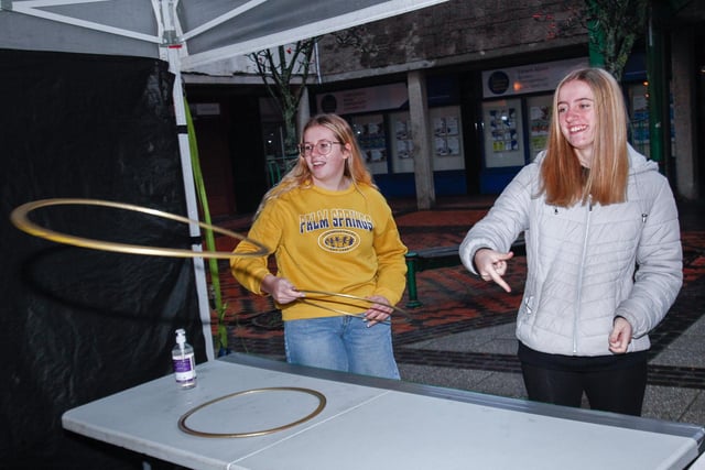 Rachel and Katie try their luck at the Christmas tree ring toss game in Grangemouth.
