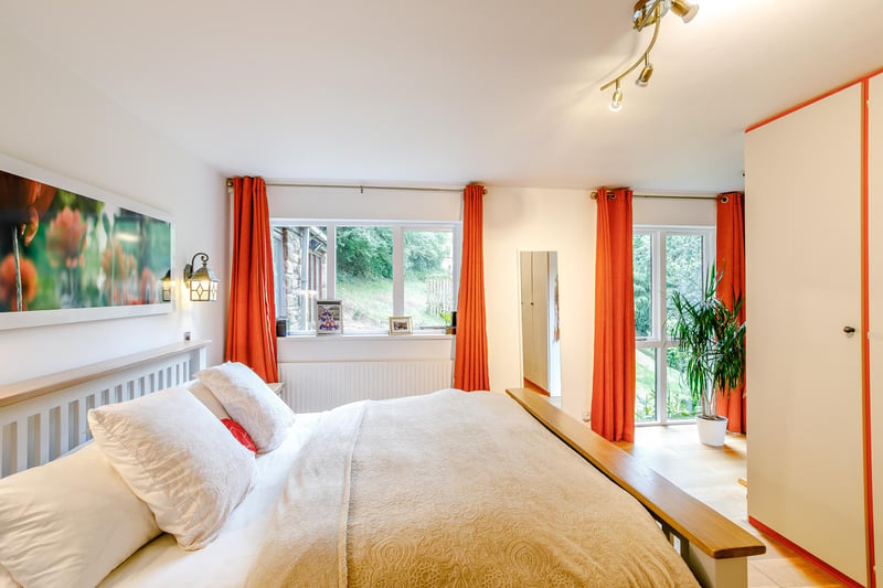 A principal bedroom occupies the east corner of the house, enjoying a double fronted view across the side garden, a dressing area with fitted wardrobes and an en-suite three piece shower room