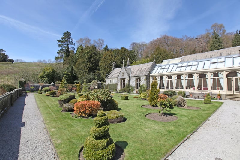The property is set in 15.56 acres of gardens, park and ancient woodland